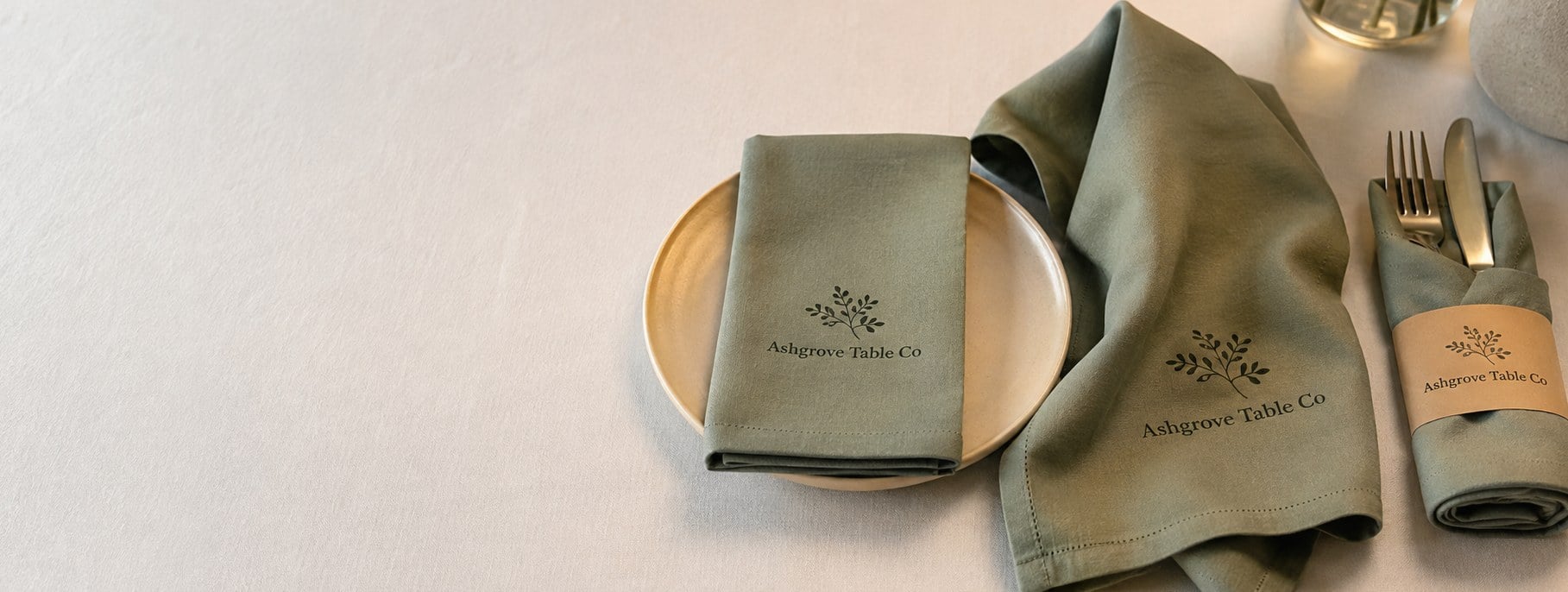 Custom printed dinner napkins with logo folded on a set table